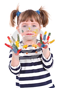 Four-year girl with hands soiled in a paint.