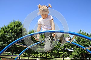 The four-year girl playing on the playground.