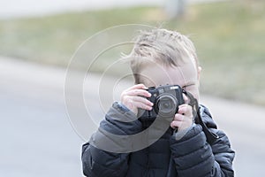 Four Year Old Toddler Boy Taking Photos Outside with a Camera