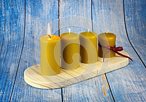 Four yellow candles on an advent candle