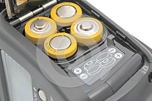 Four yellow rechargeable batteries in camera flash, close up