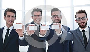 Four young business people showing their business card