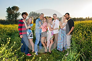 Four young couples in the country at sunset.