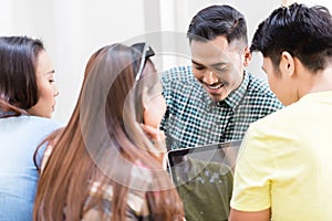 Four young employees sharing opinions and information in the office