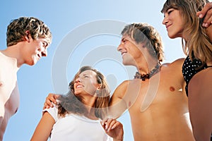 Four young people on the beach