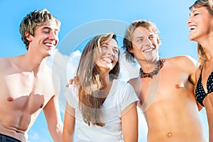 Four young people on the beach