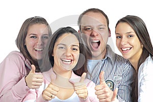 Four young people showing thumbs up
