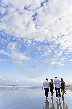 Four Young People, Two Couples, Walking On A Beach