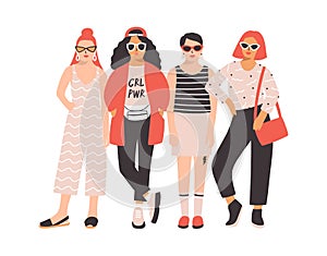 Four young women or girls dressed in trendy clothes standing together. Group of friends or feminist activists. Female photo