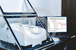 Fourier Transform Infrared Spectroscopy FTIR Instrument and IR spectrum shown on monitor