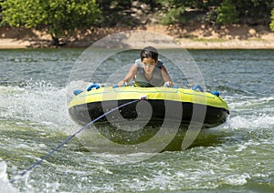 Fourteen year-old Amerasian boy tubing on Grand Lake in Oklahoma.