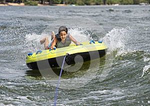 Fourteen year-old Amerasian boy tubing on Grand Lake in Oklahoma.