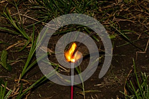 Fourth of July sparkler with ground back ground