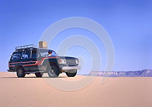 Fourwheeldrive in the desert driving by woman