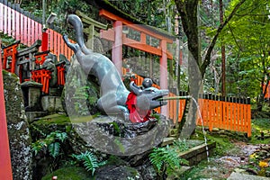 Fox Statue Water fountain in Fushimi Inari Shrine - Kyoto, Japan