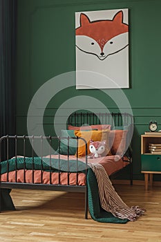 Fox theme in cute bedroom interior with green wall and orange bedding