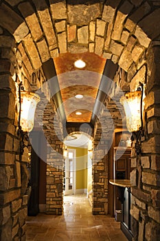 Foyer with stone archway in home.