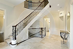 Foyer with wrought iron staircase railing