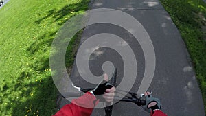 FPV of biker riding bike on asphalt road.