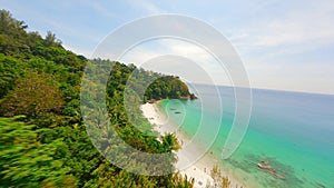 FPV drone flying over the beautiful tropical coastline of Phuket island.