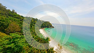 FPV drone flying over the beautiful tropical coastline of Phuket island.