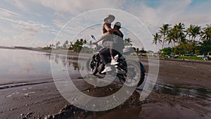 FPV drone view custom bike riding tropical sandy beach pregnant wife on knees