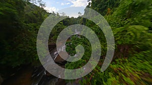 FPV flight over tropical river among the lush jungle in Thailand