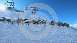 FPV POV of cable chair ski lift ascend for alpine skiing in Dolomites, Italy