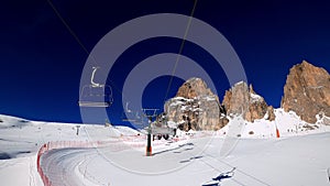 FPV POV of cable chair ski lift ascend for alpine skiing in Dolomites, Italy