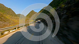 FPV Of Truck driving on scenic mountain road on the Ha Giang Loop, North Vietnam