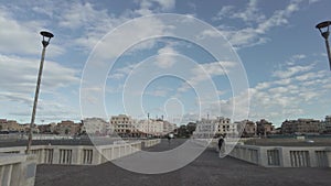 Fpv walking on the pier during a beautiful day with fantastic sky and city skyline in Rome