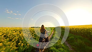 FPV of woman and dog riding a vintage motorcycle in the countryside at sunset