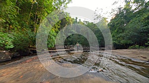 FPV of Woman Practices Yoga by the River in Tropical Rainforest, Thailand