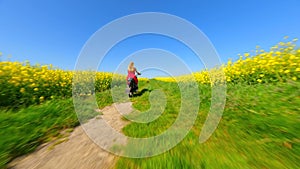 FPV of woman in red dress and dog riding a vintage motorcycle in the countryside