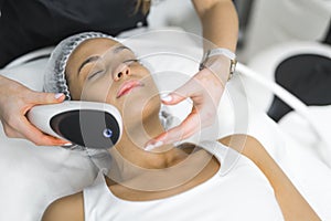 Fractional laser used in professional SPA facility. Spot treatment concept. Medium closeup indoor portrait of young