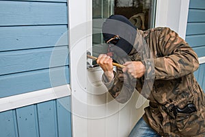 Fractional man breaking into a residential building in Finland. photo