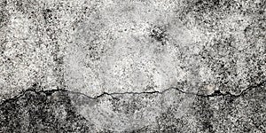 Fractured concrete wall or floor. Damaged wall background. Gray grunge cement surface with large cracks