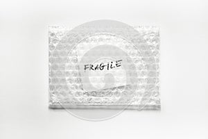 Fragile, handwriting on white squre paper in bubble pack