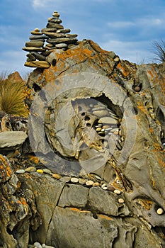 Fragile land art with smooth stones and pebbles on an eroded rock