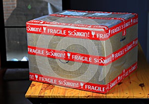 Fragile marked parcel, Cardboard boxes with Fragile symbol on wooden table