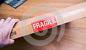 Fragile signage on the cardboard box of a new parcel delivered by freight