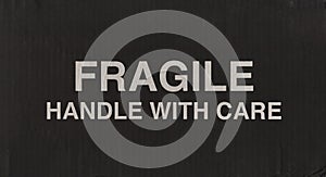 fragile signo on black corrugated cardboard box photo