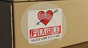 Fragile sticker on cardboard box closeup