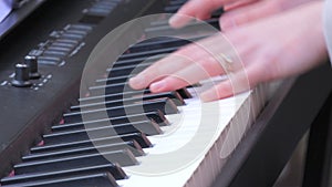 Fragile tender female hands playing a synthesizer outside in the cold season