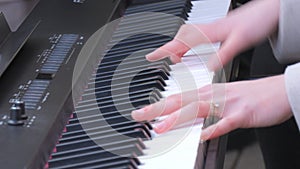Fragile tender female hands playing a synthesizer outside in the cold season