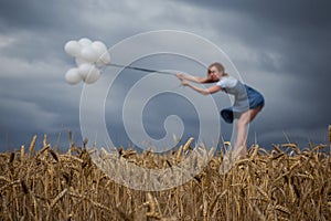 Fragile Woman Keeps Balloons Against Strong Wind