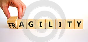 Fragility or agility symbol. Concept words Fragility and Agility on wooden cubes. Beautiful white table white background.