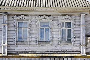Fragment of a 19th century wooden white house with carved platbands in Gorodets, Russia