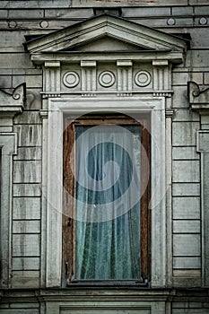 Fragment of an ancient building. Window of an old stone house. Aged texture