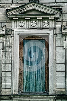 Fragment of an ancient building. Window of an old stone house. Aged texture